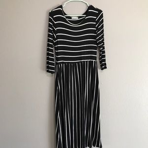 Black and white stripe midi dress with pockets.